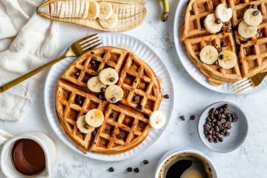 banana waffles topped with banana slices and chocolate chips