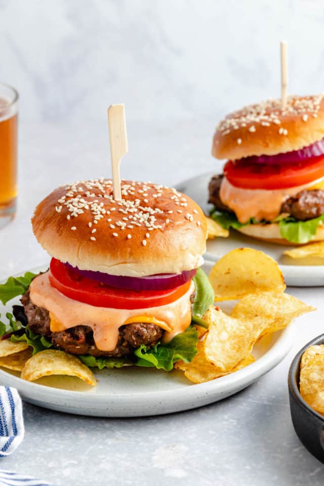 healthy burgers made with lean ground beef on a bun with lettuce, tomato and onion