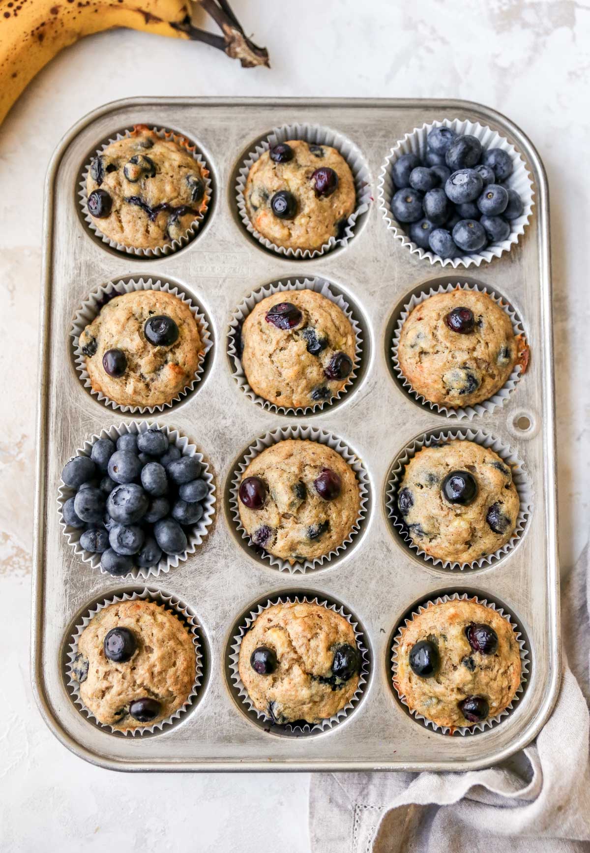 Cooked blueberry muffins in a pan.