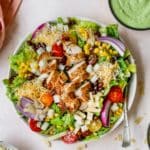 southwest salad topped with chicken, cheese and tortilla strips