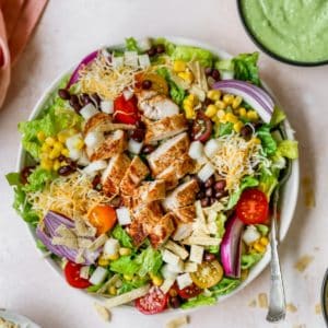 southwest salad topped with chicken, cheese and tortilla strips