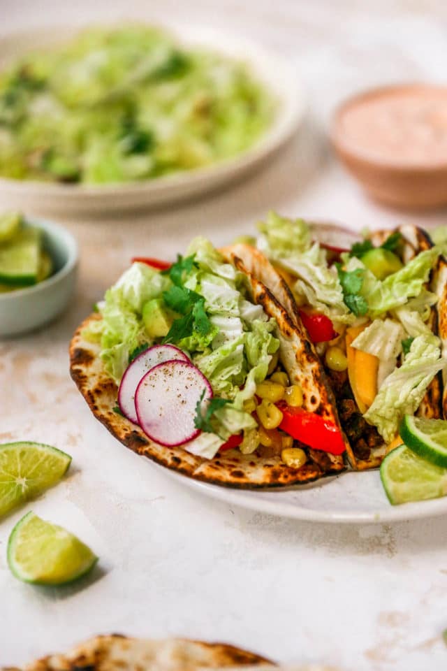 charred flour tortillas with roasted veggies, cabbage, and radishes