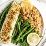 Baked halibut recipe plated with roasted green beans and rice.