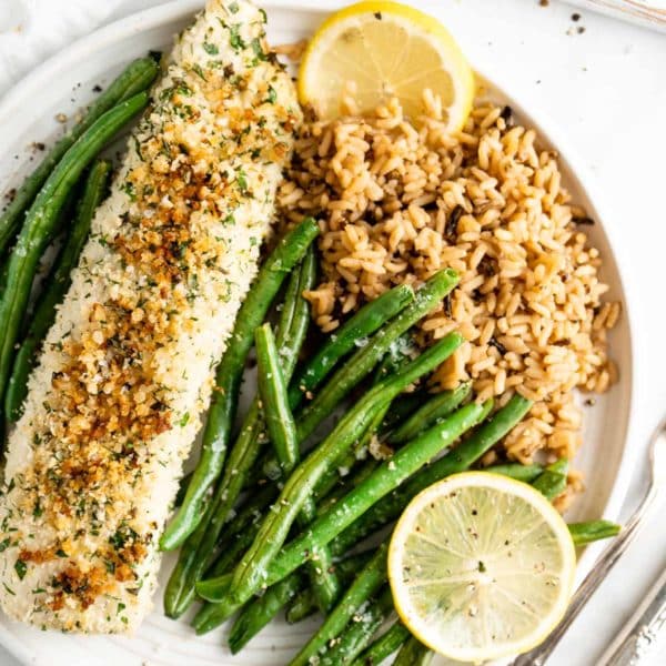 baked halibut plated with roasted green beans and rice