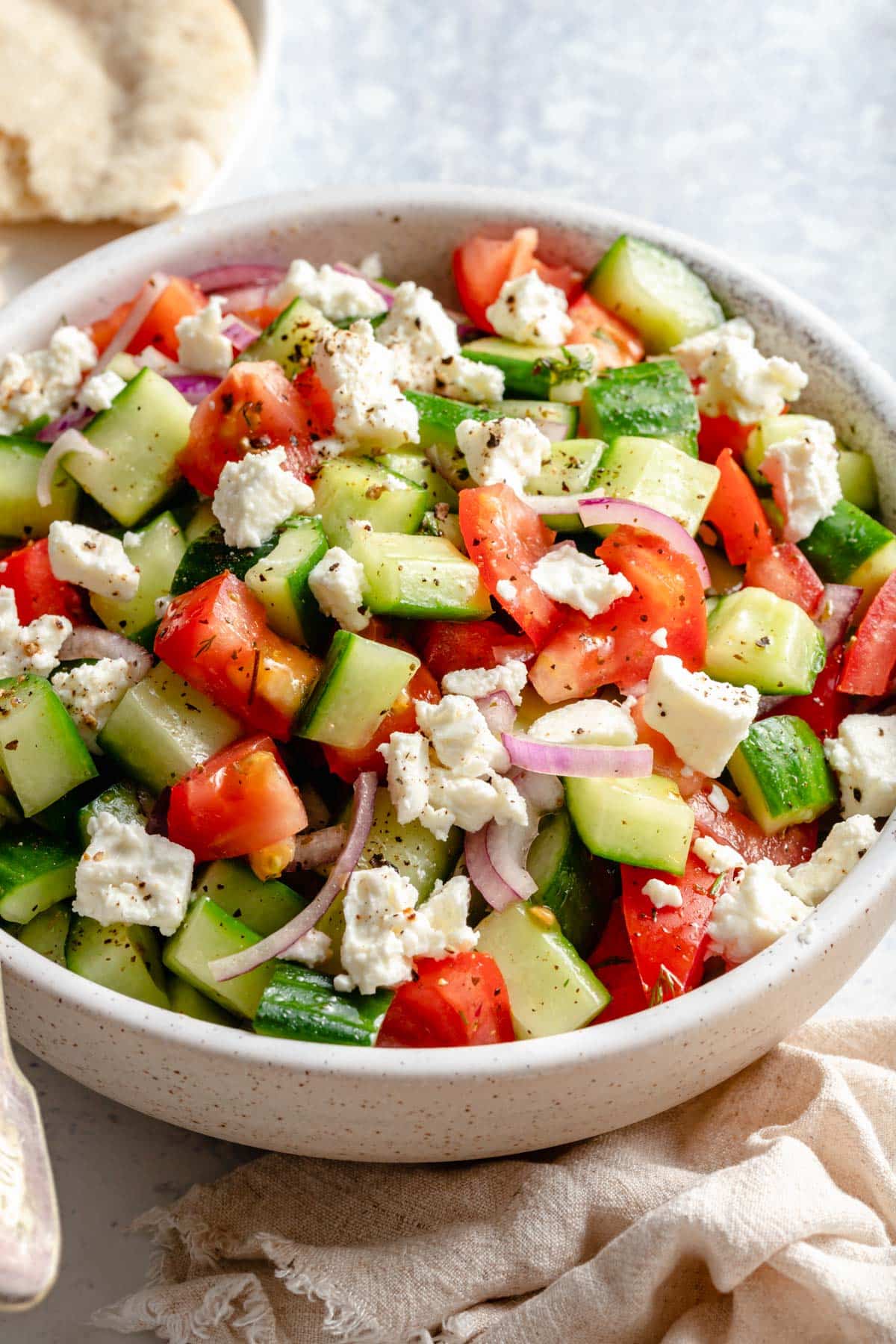 chopped veggie salad in a white bowl