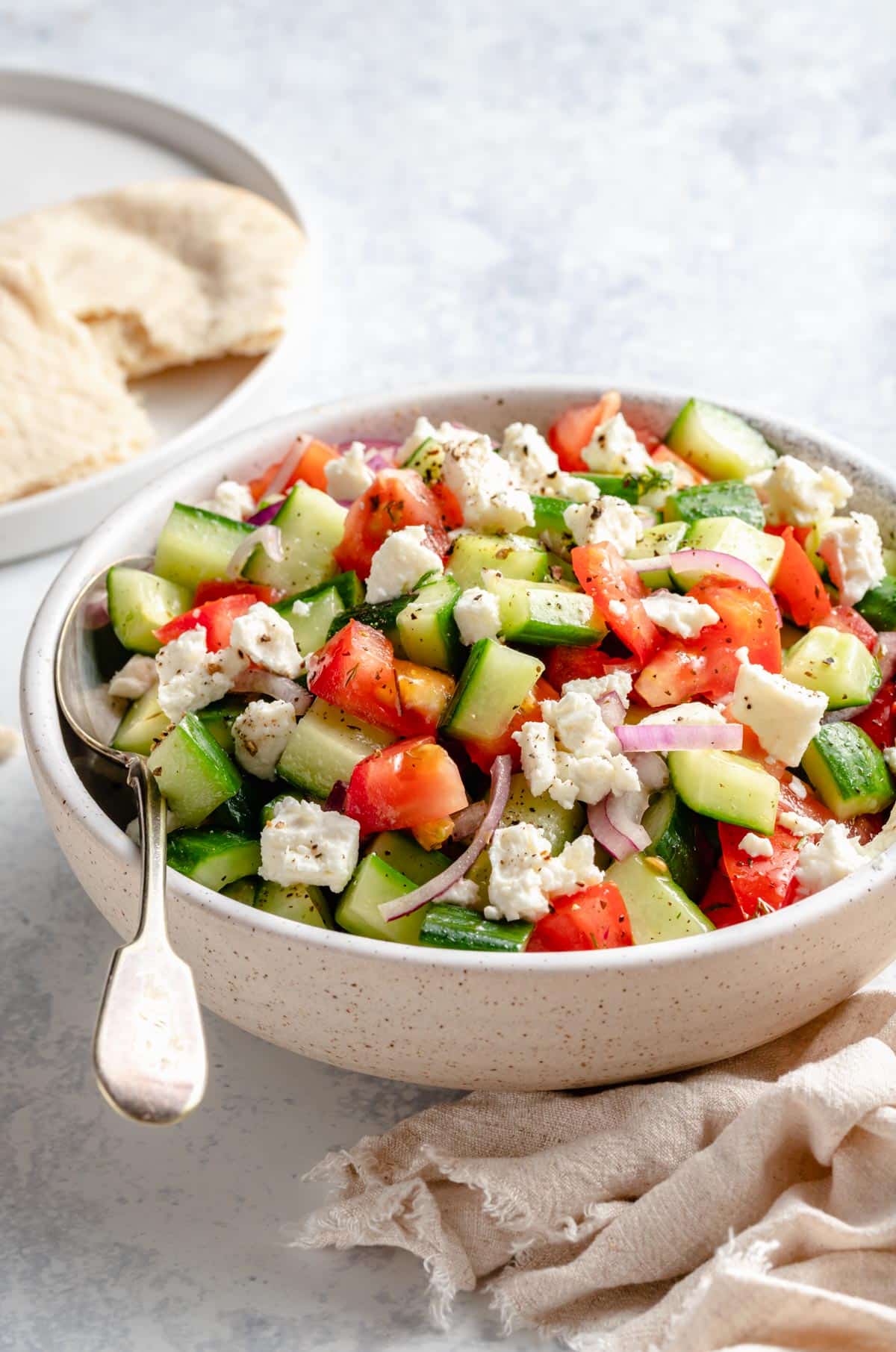 salad made with chopped cucumber, tomato and sliced red onion