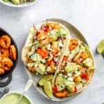 shrimp tacos topped with diced avocado
