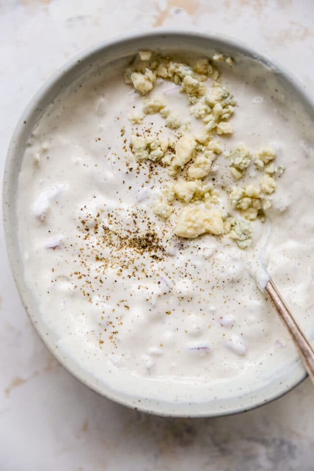 homemade blue cheese dressing topped with extra blue cheese crumbles
