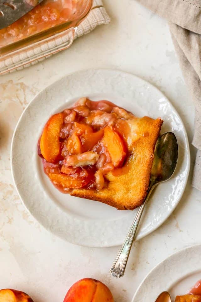 peach dessert on a plate with a spoon