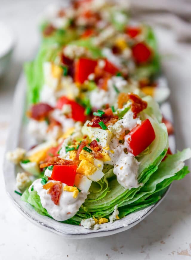 wedge salad with dressing, chopped tomatoes and bacon