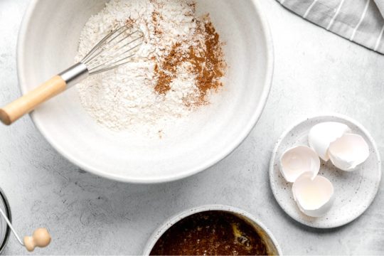 whisking flour with nutmeg and cinnamon