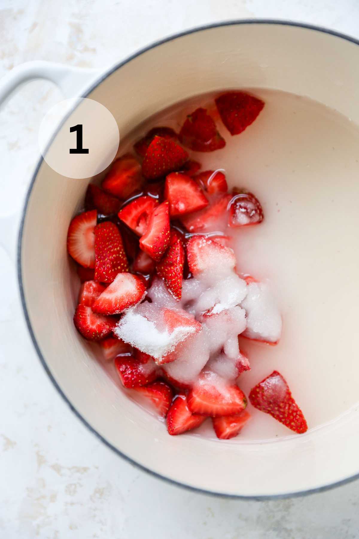 Strawberries, water and sugar in a pot.