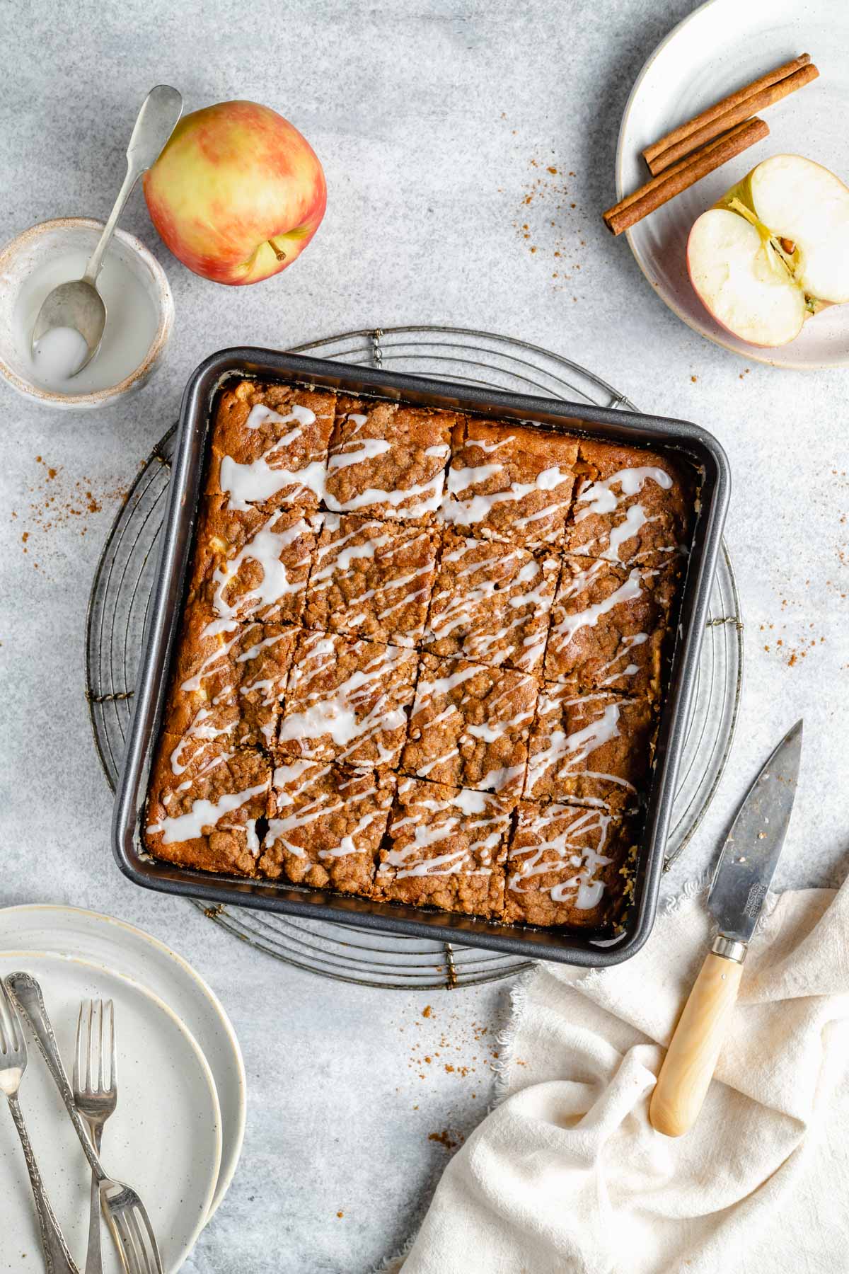 Apple coffee cake with a glaze drizzled over the top.