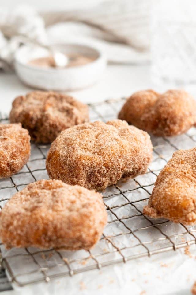 cinnamon sugar fritters on wire cooling rack