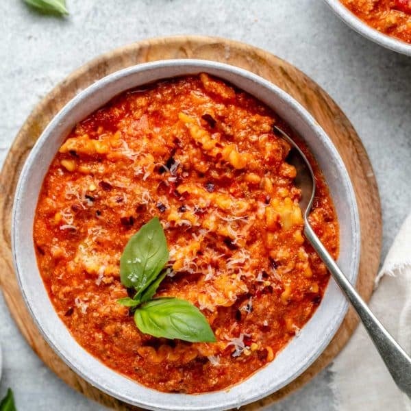 lasagna soup served in a bowl and garnished with parmesan cheese and fresh basil