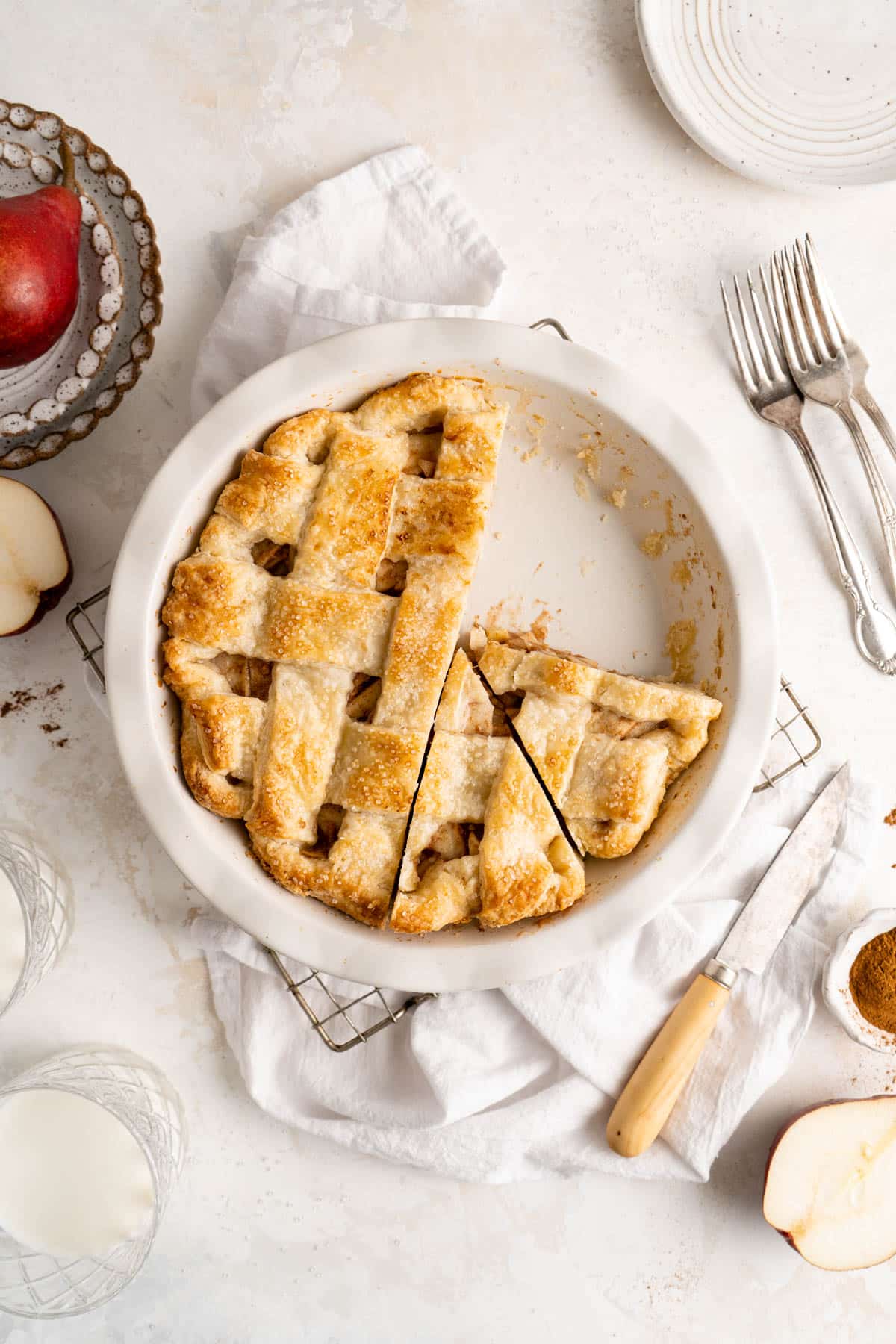 Sliced pear pie in a pie plate.