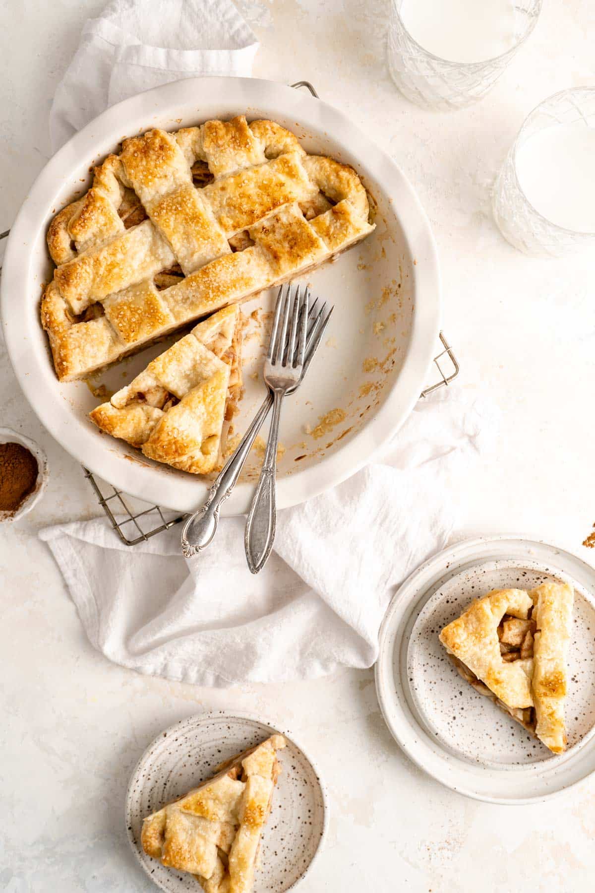 Slices of pear pie on white plates.