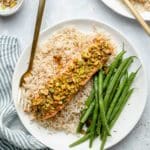 Pistachio-Crusted Salmon served on a plate with rice and green beans
