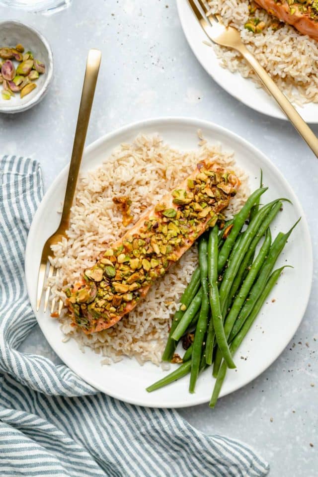 Pistachio-Crusted Salmon served on a plate with rice and green beans