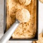 Scooping out Pumpkin Ice Cream from a loaf pan.