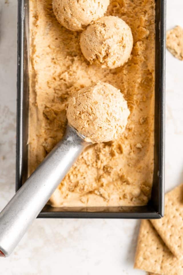 scooping out Pumpkin ice cream from a loaf pan