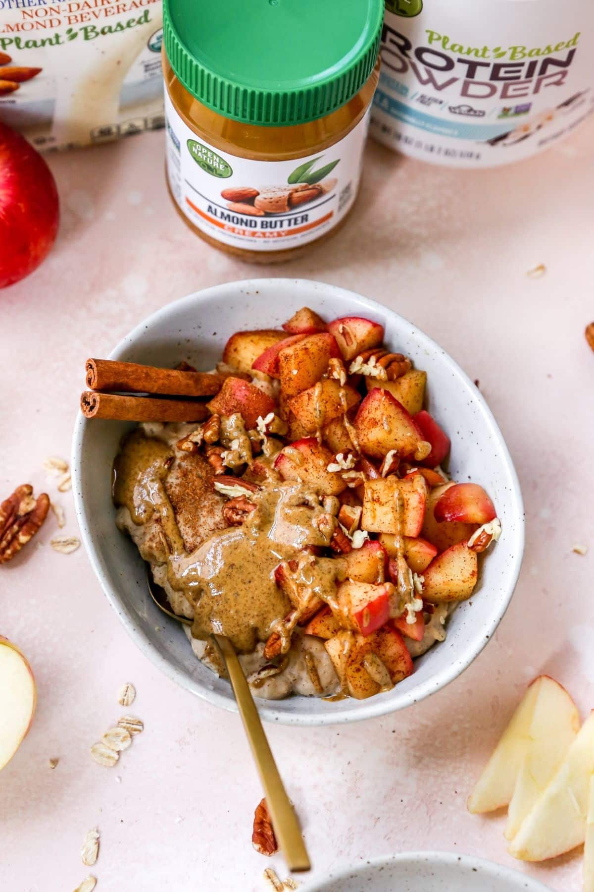 Bowl filled with oatmeal, diced apples and almond butter.