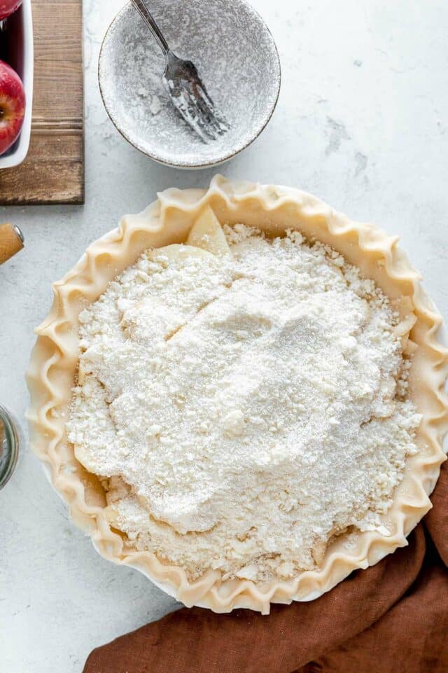 Apple pie with crumb topping before being baked.