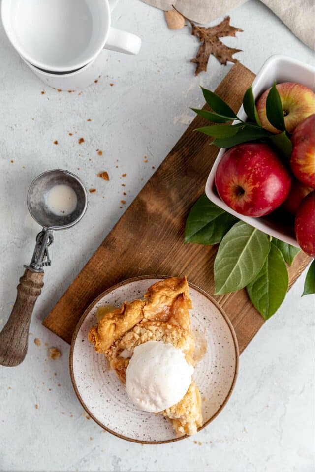 Apple pie served with a scoop of ice cream.