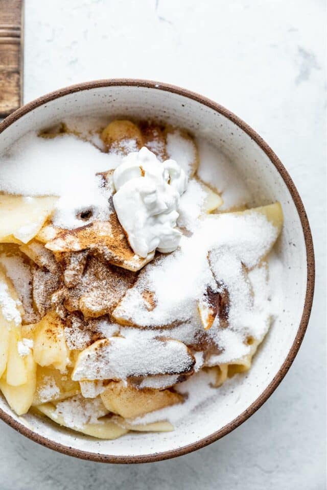 Apple slices tossed with sugar and spices.