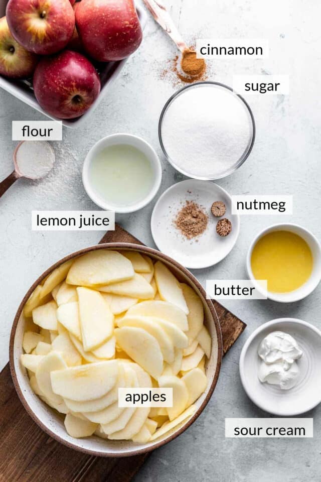 Apple slices, sugar, lemon juice, melted butter, sour cream and spices divided out into portions.