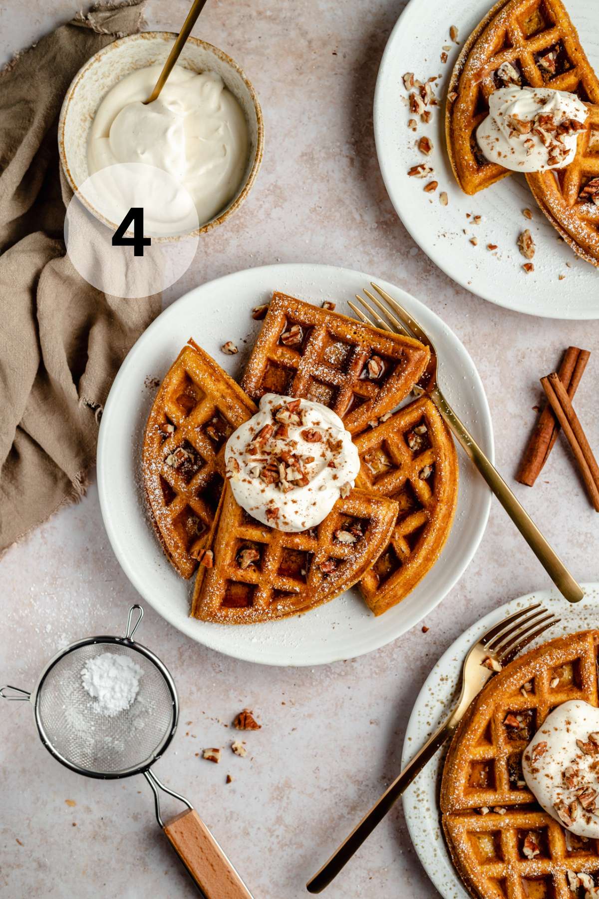 Pumpkin waffles served with yogurt, powdered sugar, chopped pecans and syrup.