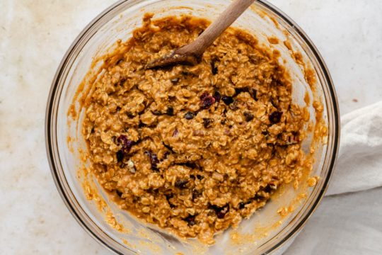 mixing oats with pumpkin and chocolate chips in a large mixing bowl