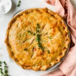 Chicken pot pie garnished with fresh thyme.