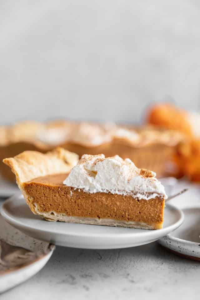 slice of pumpkin pie on a small white plate