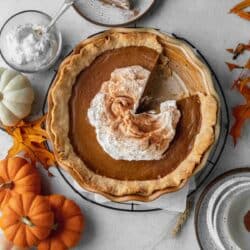 Pumpkin pie in a flaky crust and topped with whipped cream.