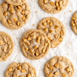 butterscotch cookies topped with sea salt on parchment paper