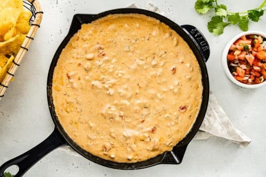 cheese dip with sausage served with tortilla chips