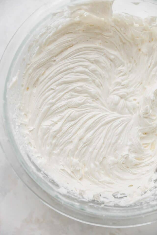 Mixing cream cheese and Cool Whip in a large bowl.