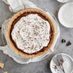 Chocolate pudding pie topped with cool whip and chocolate shavings.