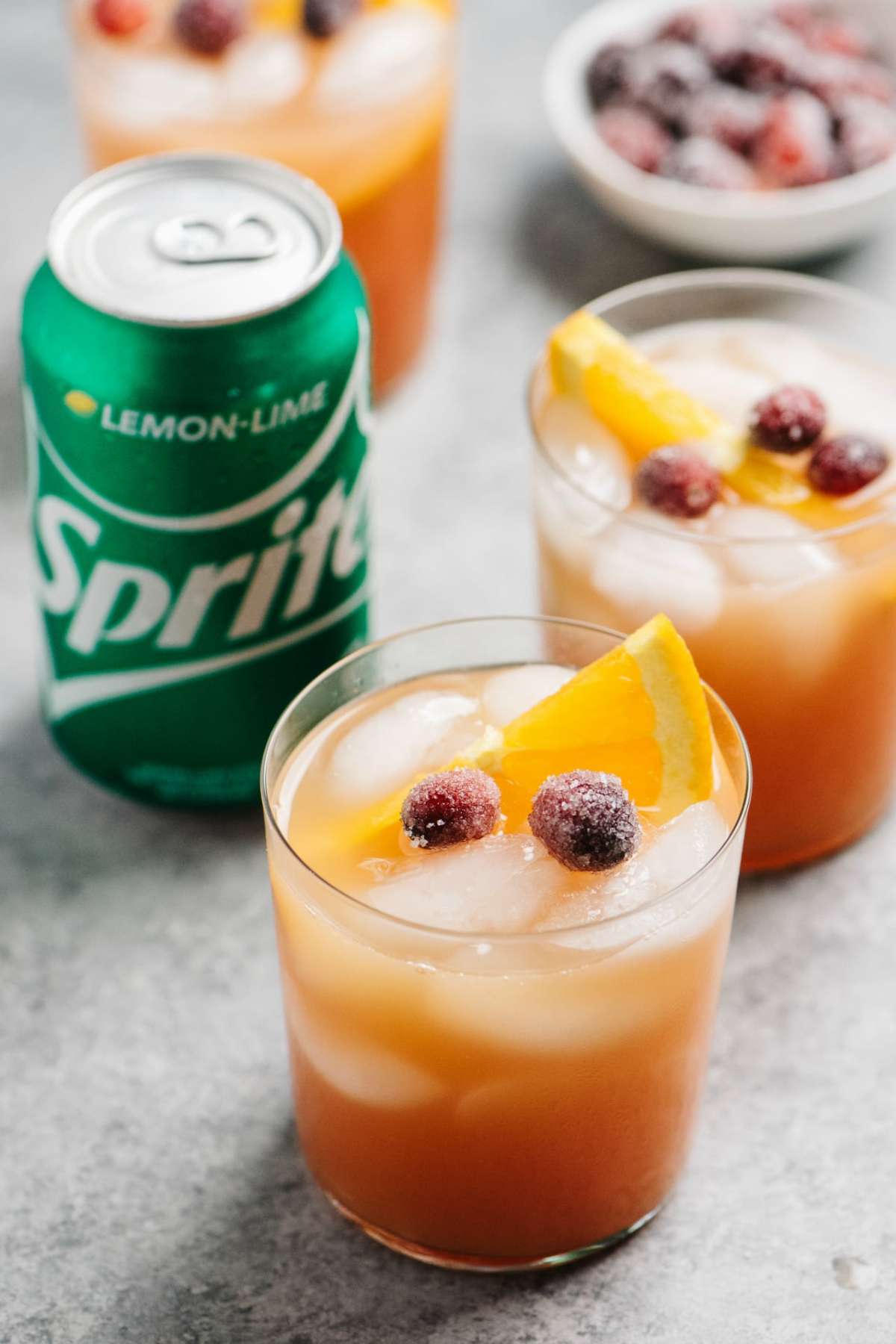 Cranberry cocktail near a can of Sprite.