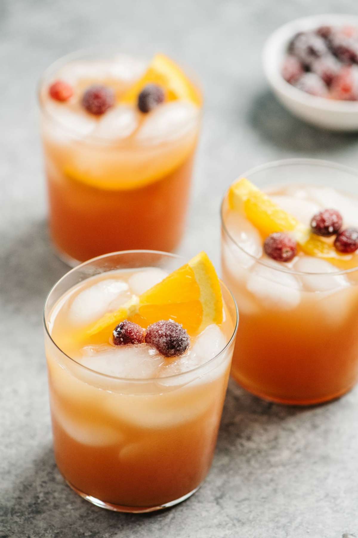Cranberry cocktail garnished with cranberries and orange slices.