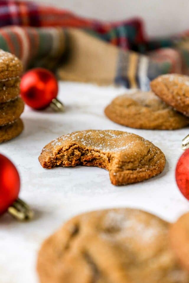 Soft cookie with a bite taken out near a Christmas ornament.