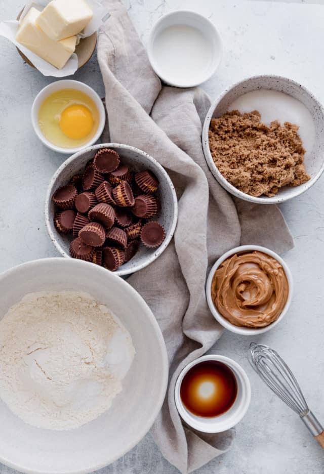 ingredients to make peanut butter cup cookies divided into small bowls