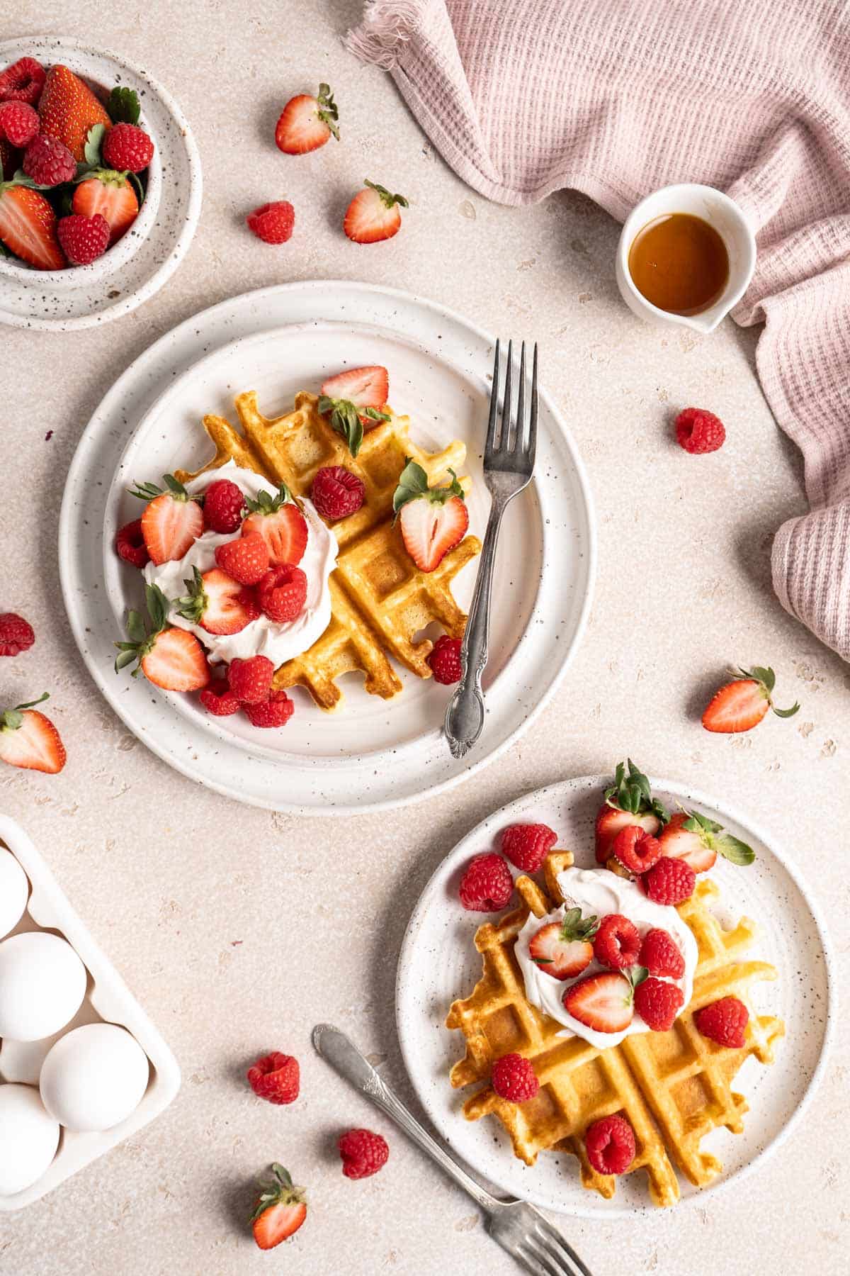 fluffy waffles served with whipped cream and berries