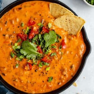 Black-eyed pea dip with tortilla chips dipped in.