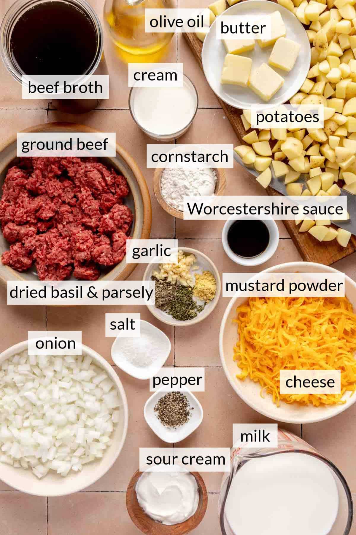 Ingredients for cheeseburger soup in small bowls.