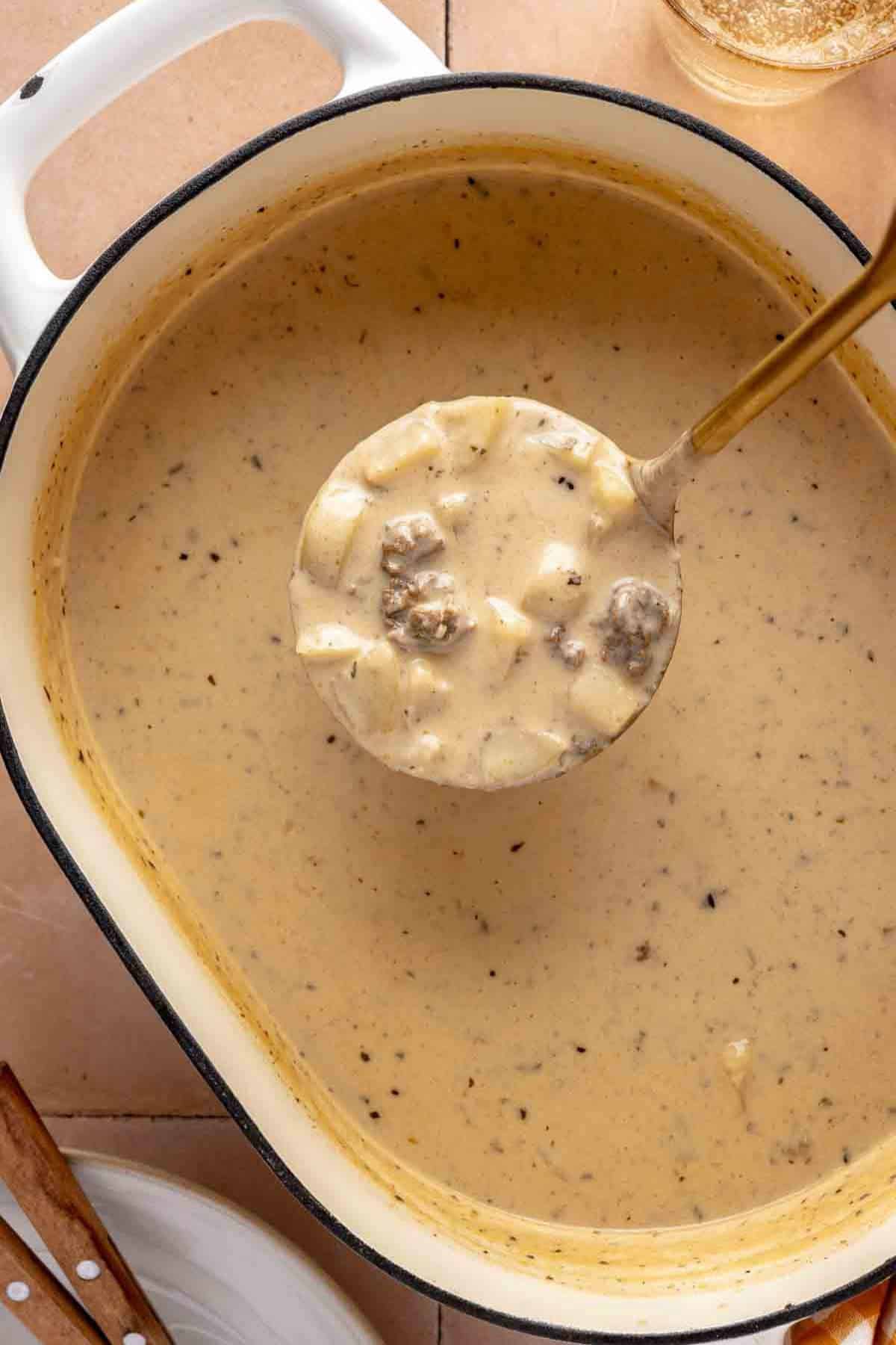 Ladling soup out of a pot.