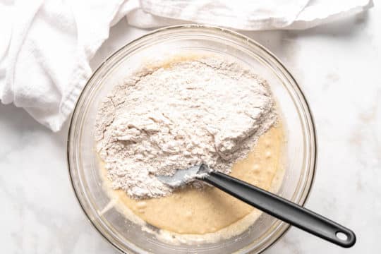 combining flour mixture with wet ingredients for banana cookies