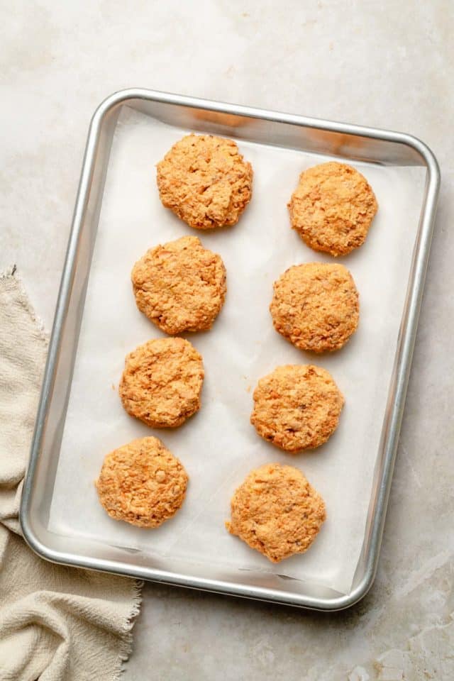 8 raw salmon patties on a pan lined with parchment paper