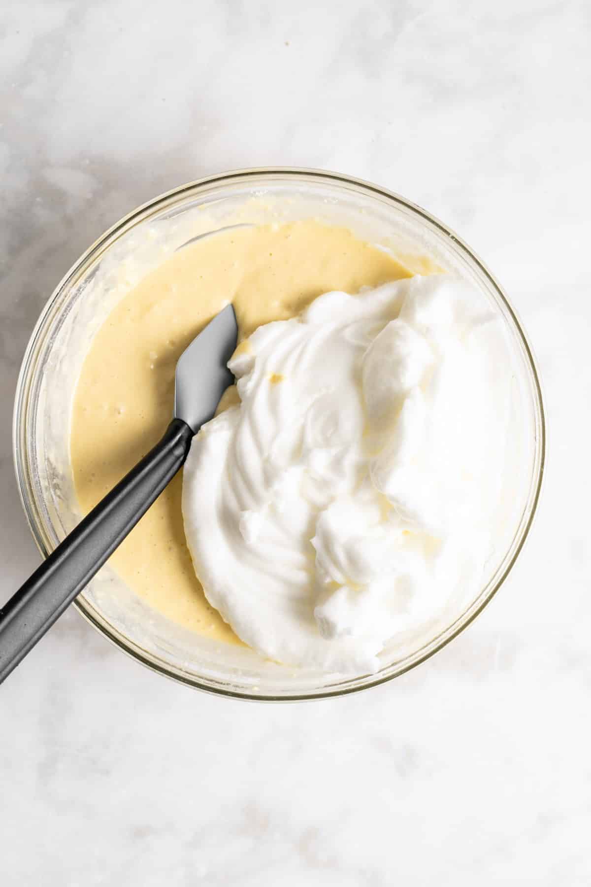 Fold egg whites into waffle batter.